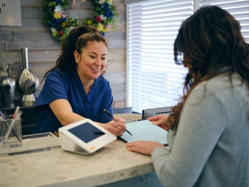 Front desk staff assisting a patient